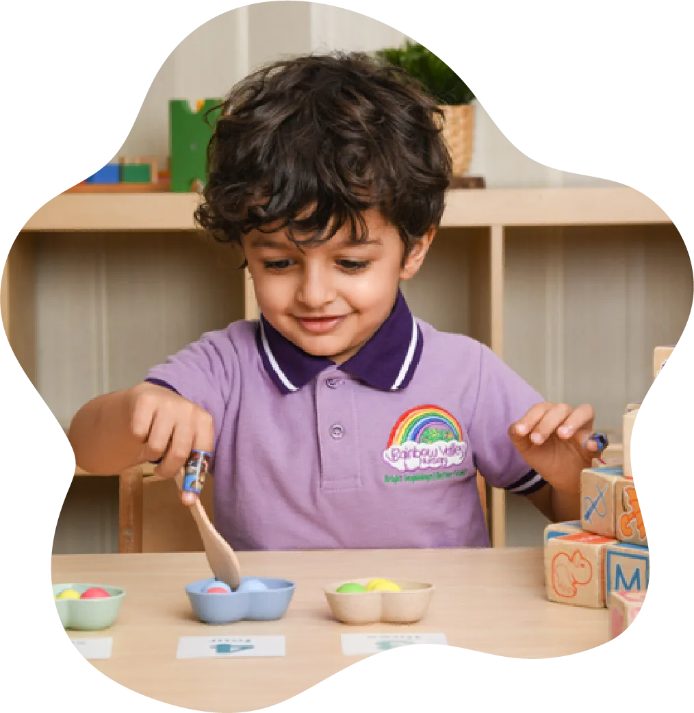 Child in nursery uniform doing a craft activity
