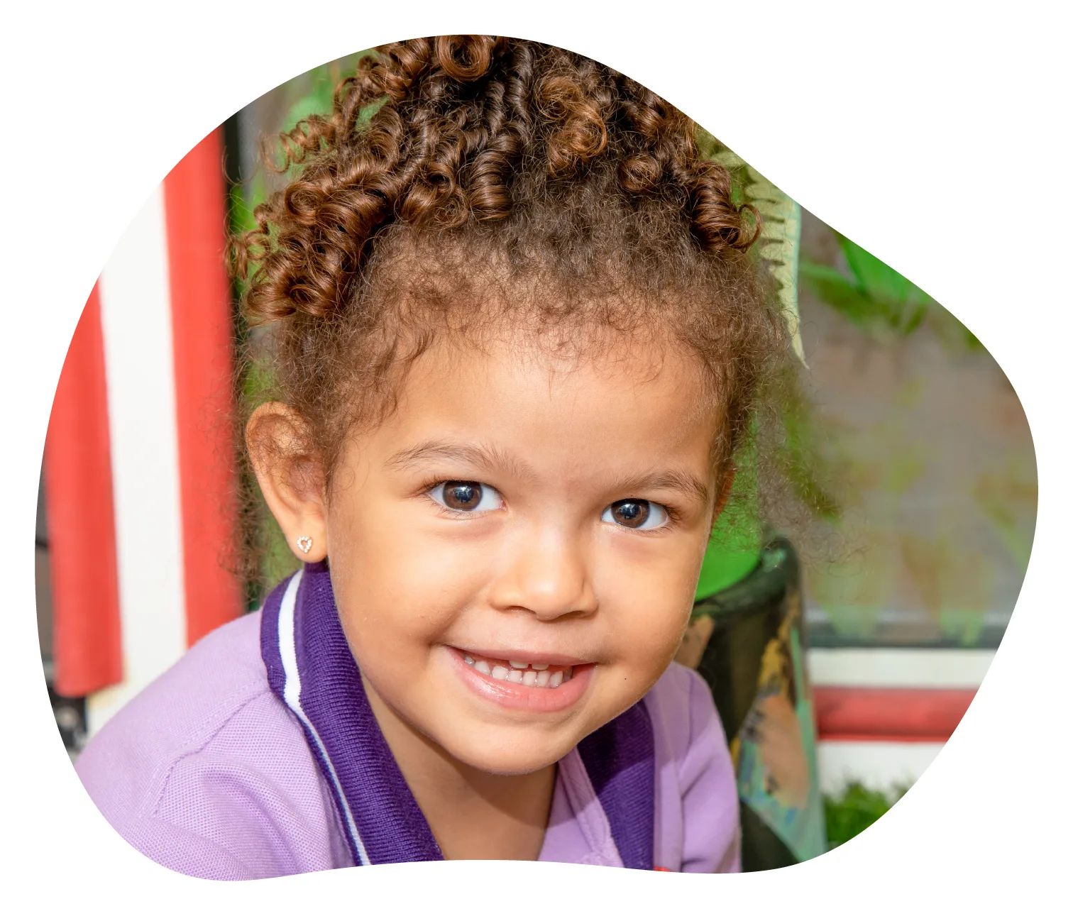 Smiling girl in Rainbow Valley Nursery uniform
