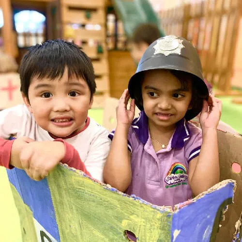 Two children in sun hats smiling outdoors