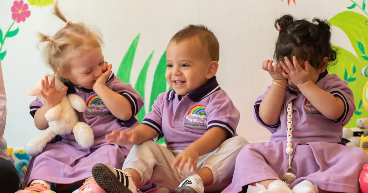 Toddlers in Rainbow Valley Nursery uniforms playing together in a JLT classroom