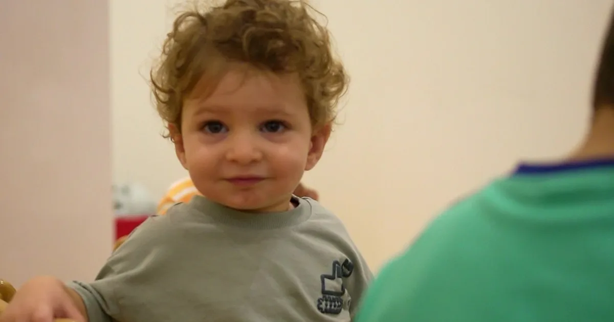 A curious toddler at Rainbow Valley Nursery looking at the camera