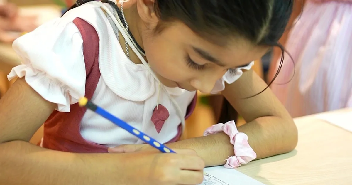 A Rainbow Valley Nursery preschooler practising early writing with a pencil